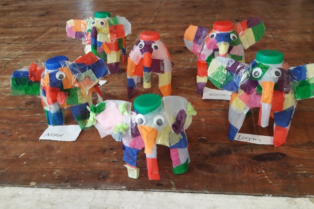 Multi-coloured small elephants made from milk cartons